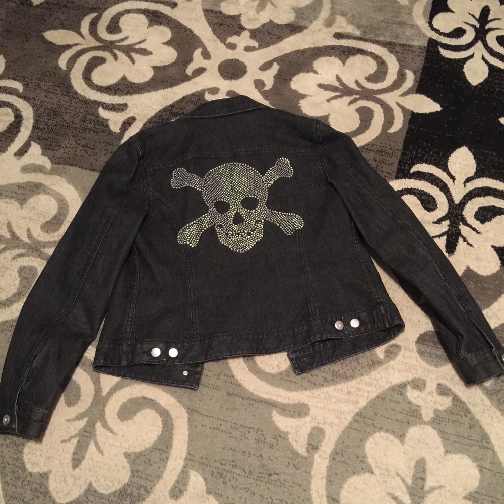 Black denim jacket with skull and cross bones